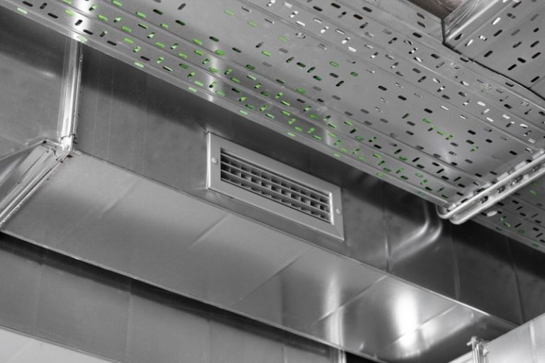 Close-up view of a metal ventilation duct and air vent system