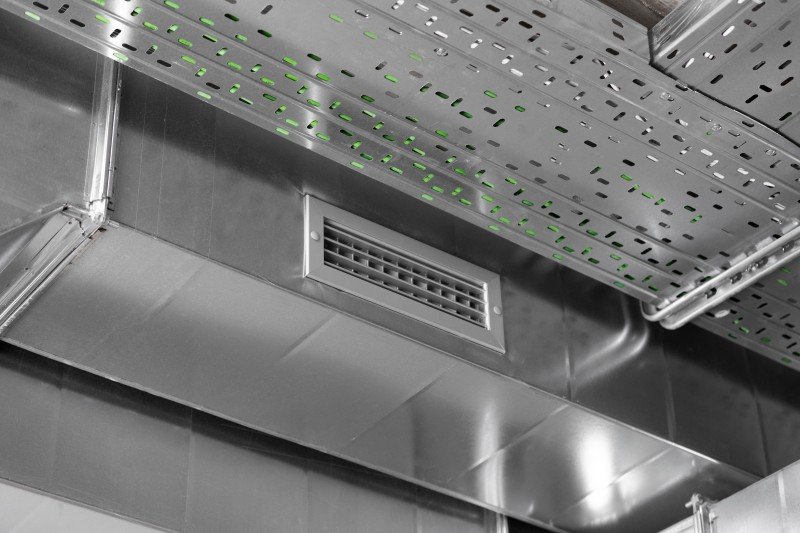 Close-up view of a metal ventilation duct and air vent system