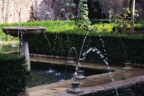 Decorative garden fountain with multiple water jets